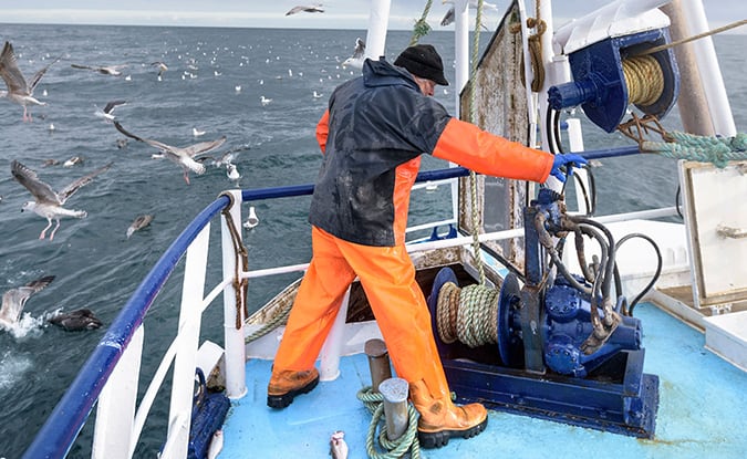 Fisherman on a ship fishing for sustainable seafood