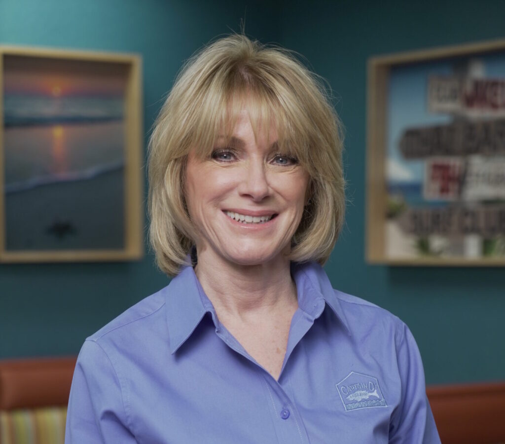 Lisa Starnes smiling while standing inside a Captain D's