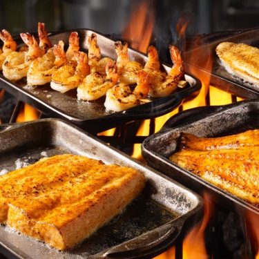 Seafood on the grill, showing shrimp and fish fillets